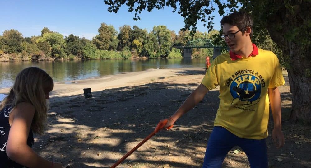 International exchange student volunteering to clean up park