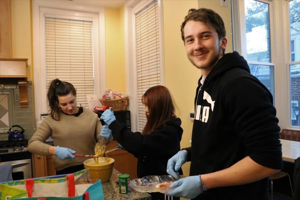 exchange students volunteering at food kitchen
