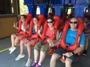 Exchange students with their host family on roller coaster