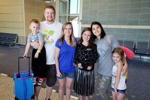 Host family welcoming their exchange student at the airport