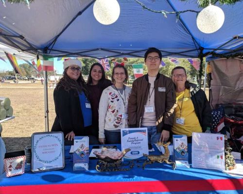 area rep table area representative with exchange students at booth