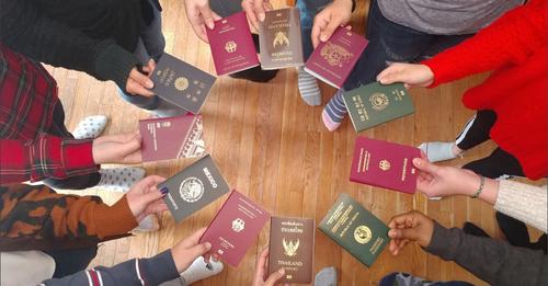 People in Circle Holding Passports